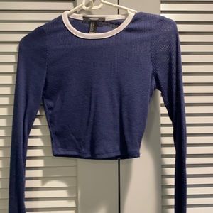Navy blue cropped sweater with white trim at neck